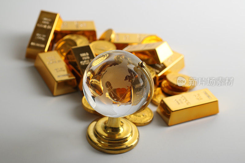 Coins and ingots with glass globe